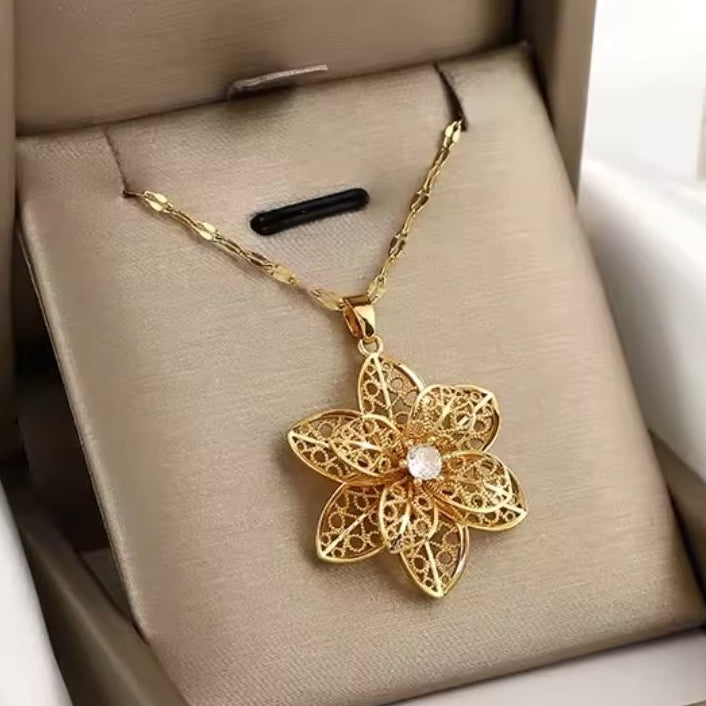 Mrs. Claus Necklace - Gold Rotating Poinsettia