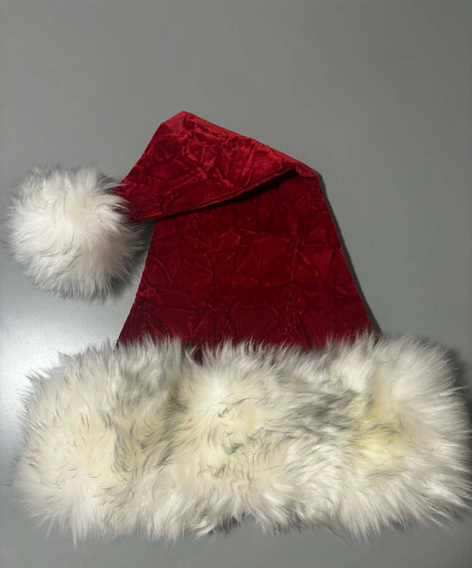 Red Santa hat with white fur trim on a plain background