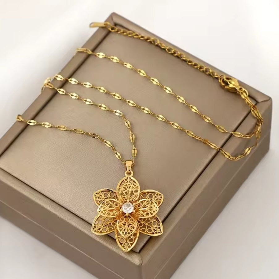 Mrs. Claus Necklace - Gold Rotating Poinsettia