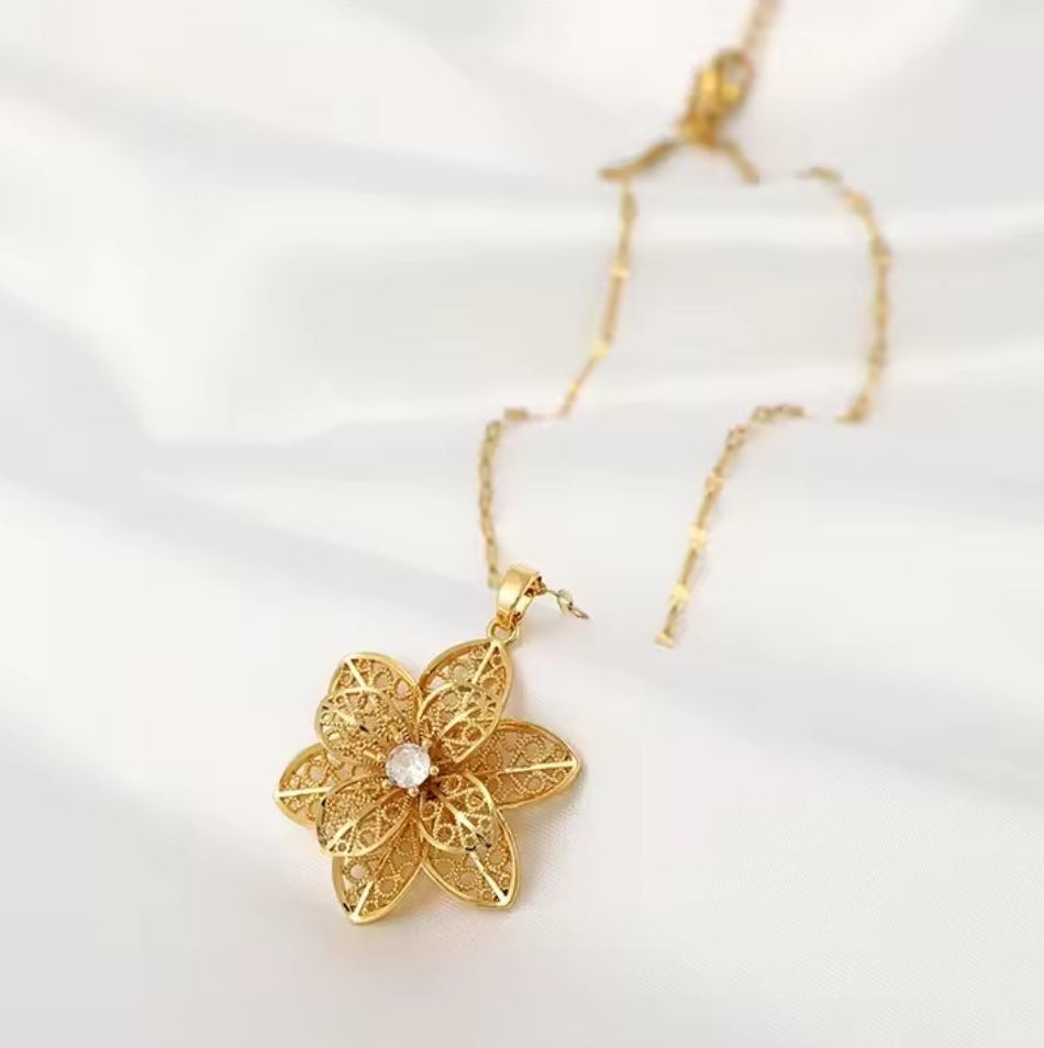 Mrs. Claus Necklace - Gold Rotating Poinsettia