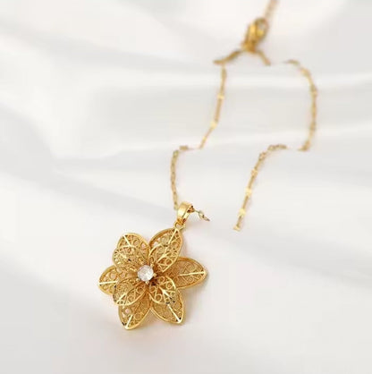 Mrs. Claus Necklace - Gold Rotating Poinsettia