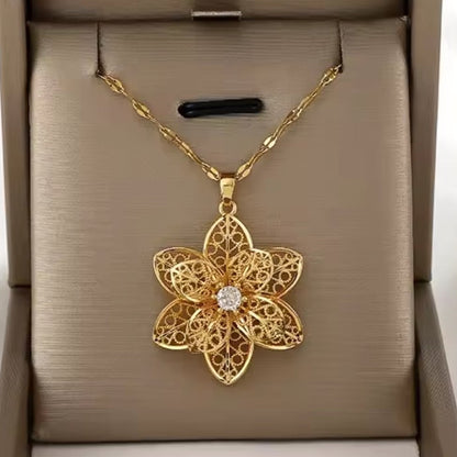 Mrs. Claus Necklace - Gold Rotating Poinsettia